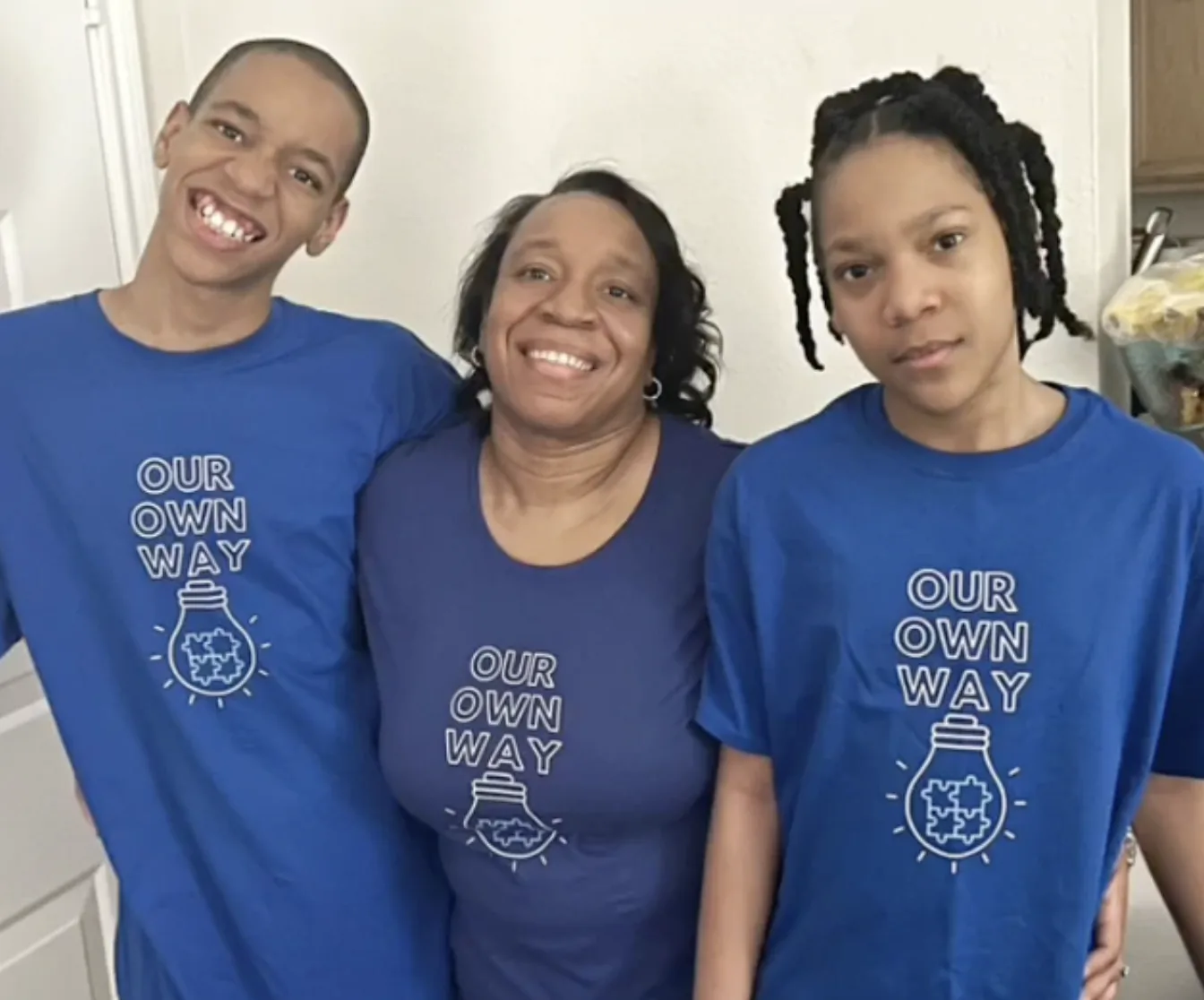 Family wearing matching autism awareness shirts.